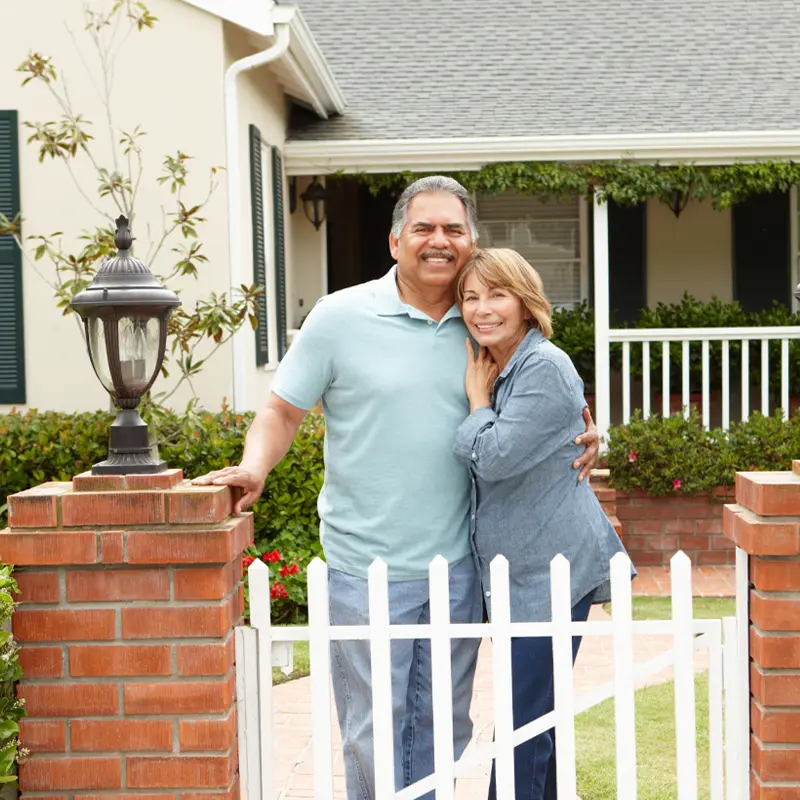 Portrait of couple in front of their home
